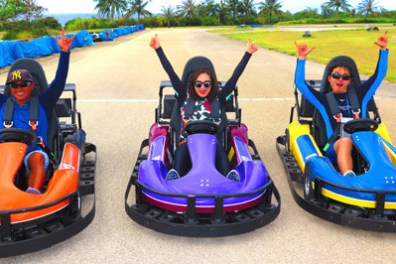 Three guests sitting at the finish line giving two thumbs up
