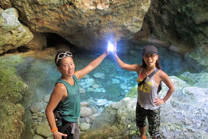 Two people high-fiving at the forbidden pool