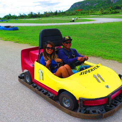 Two people enjoying a ride in a go kart