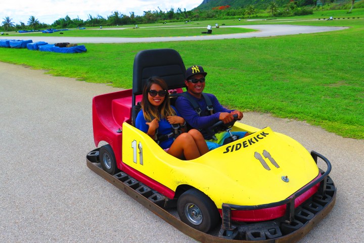 Two people enjoying a ride in a go kart