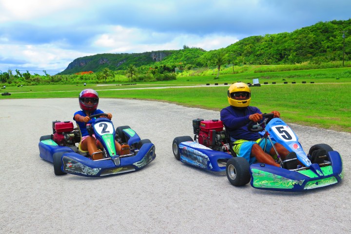 Two people drinking go karts