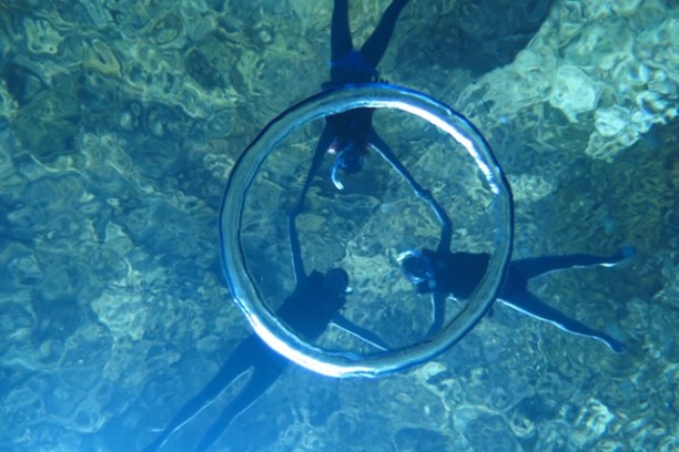 A group of guests playing with a bubble ring