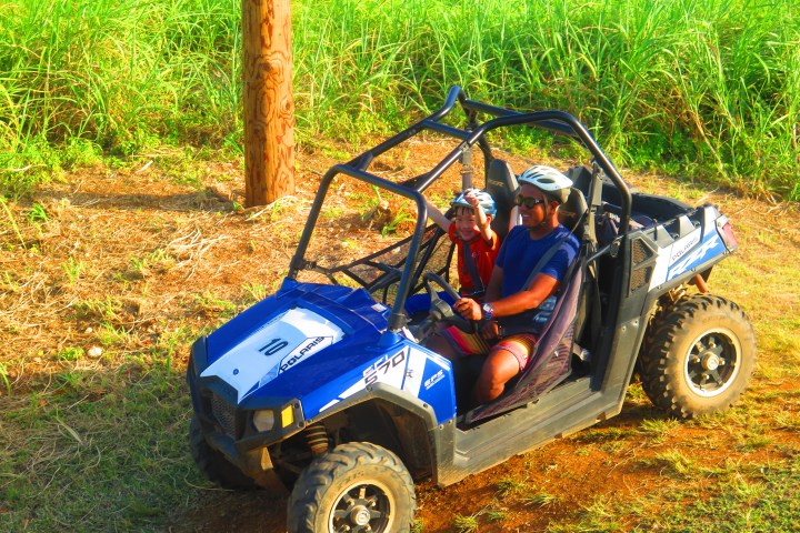 A father and his son enjoying a ride on a buggy